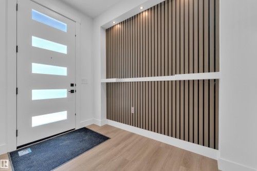 Contemporary entry featuring a white door with horizontal glass panels - 13128 187 Avenue, Edmonton, AB - Indoor Photo Showing Other Room