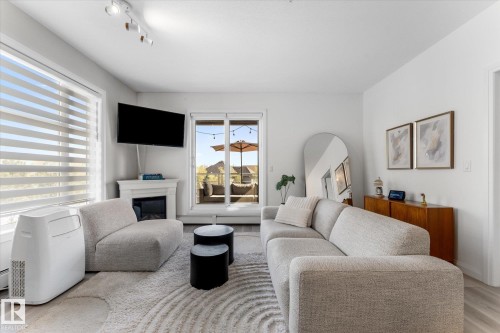 313 2590 Anderson Way, Edmonton, AB - Indoor Photo Showing Living Room With Fireplace