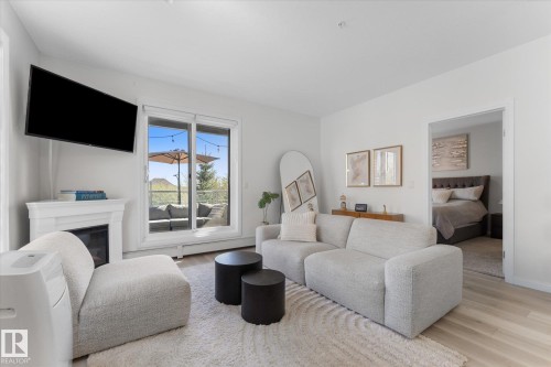 313 2590 Anderson Way, Edmonton, AB - Indoor Photo Showing Living Room With Fireplace