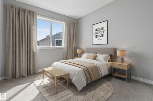 This room features a window providing natural light, carpeted flooring, and light gray wall paint - 15 2072 Wonnacott Way, Edmonton, AB - Indoor Photo Showing Bedroom