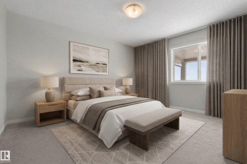 The bedroom features a window with an outside view and light-colored walls - 15 2072 Wonnacott Way, Edmonton, AB - Indoor Photo Showing Bedroom