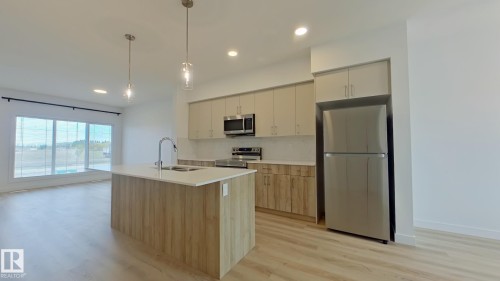 Main 1037 Aster Boulevard, Edmonton, AB - Indoor Photo Showing Kitchen With Stainless Steel Kitchen With Double Sink With Upgraded Kitchen