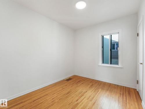Room featuring hardwood floors, a window with blinds, and a flush mount light fixture - 10645 62 Avenue, Edmonton, AB - Indoor Photo Showing Other Room