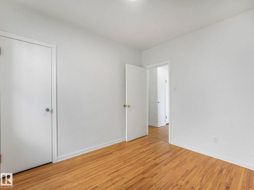 This room features light hardwood flooring and white walls, creating a bright and airy atmosphere - 10645 62 Avenue, Edmonton, AB - Indoor Photo Showing Other Room