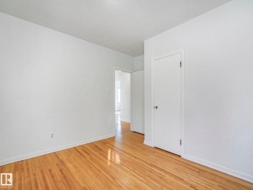 This room features hardwood floors and crisp white walls - 10645 62 Avenue, Edmonton, AB - Indoor Photo Showing Other Room