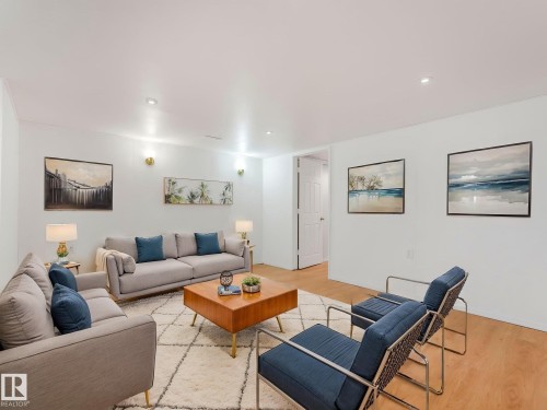 The living area features light-toned flooring, recessed lighting, and white walls - 10645 62 Avenue, Edmonton, AB - Indoor Photo Showing Living Room