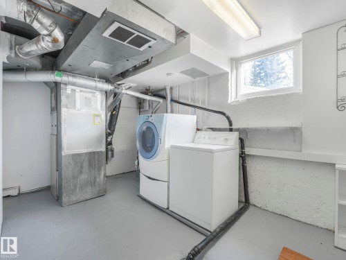 The utility area includes a washer and dryer, a forced air furnace, and a window for natural light - 10645 62 Avenue, Edmonton, AB - Indoor Photo Showing Laundry Room