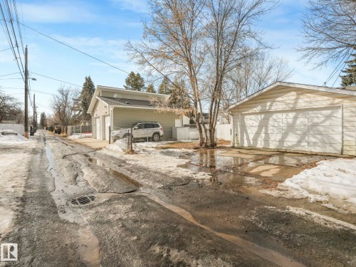 The property includes a two-car garage with a white garage door and an additional garage structure with two overhead doors - 10645 62 Avenue, Edmonton, AB - Outdoor
