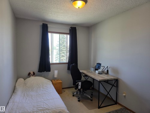 Bright room featuring a window with natural light, neutral wall paint, and carpeted flooring - 4029 55 Avenue, Drayton Valley, AB - Indoor