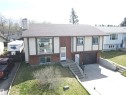 Split-level home featuring a brown shingle roof, integrated single-car garage, and a concrete driveway - 4029 55 Avenue, Drayton Valley, AB  - Outdoor 
