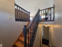 Wood-finish stairs with dark balusters and handrails - 4029 55 Avenue, Drayton Valley, AB  - Indoor Photo Showing Other Room 