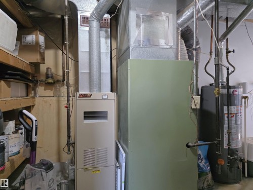 Lennox furnace and Rheem water heater with associated ductwork and plumbing - 4029 55 Avenue, Drayton Valley, AB - Indoor Photo Showing Basement