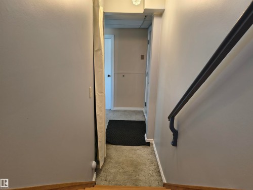 Carpeted hallway with light gray walls - 4029 55 Avenue, Drayton Valley, AB - Indoor Photo Showing Other Room