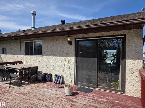 Expansive outdoor deck featuring wood flooring and direct access via a glass sliding door - 4029 55 Avenue, Drayton Valley, AB - Outdoor With Deck Patio Veranda With Exterior