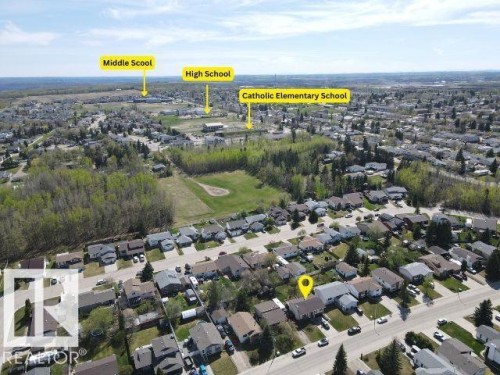 Aerial perspective of a residential neighborhood with detached homes, mature trees, and paved streets - 4029 55 Avenue, Drayton Valley, AB - Outdoor With View
