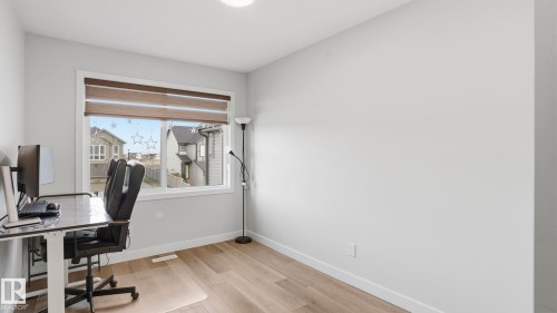 Bright room with a large window featuring horizontal blinds - 17364 2 Street, Edmonton, AB - Indoor Photo Showing Office