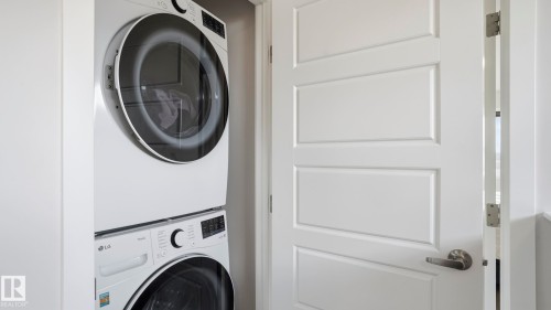 Dedicated laundry space featuring a stacked LG washer and dryer unit - 17364 2 Street, Edmonton, AB - Indoor Photo Showing Laundry Room