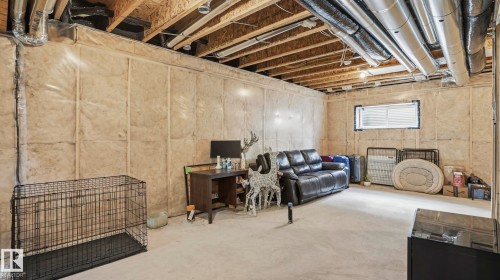 Unfinished basement offering expansive potential with exposed ceiling joists, visible ductwork, insulated wall studs, a single window, and concrete flooring - 17364 2 Street, Edmonton, AB - Indoor Photo Showing Basement