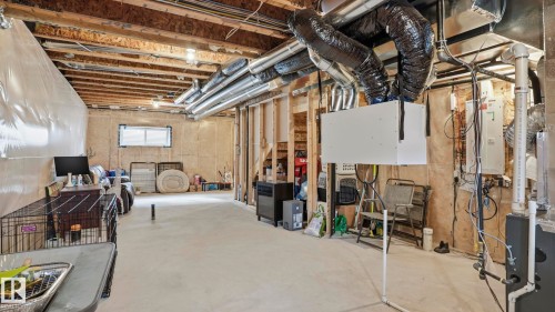Unfinished basement featuring exposed wood joists, concrete flooring, and visible ductwork - 17364 2 Street, Edmonton, AB - Indoor Photo Showing Basement