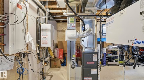 Utility area featuring a water heater, furnace, and various mechanical systems - 17364 2 Street, Edmonton, AB - Indoor Photo Showing Basement