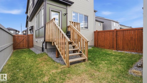 Rear exterior with a wooden staircase leading to an upper-level door - 17364 2 Street, Edmonton, AB - Outdoor