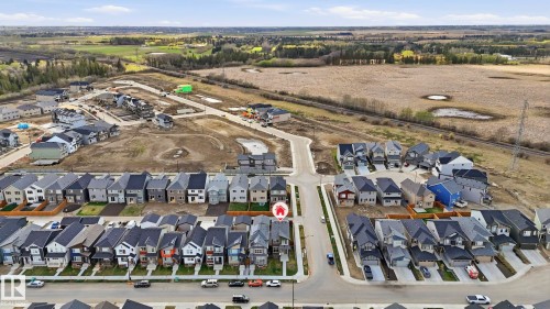 Aerial view of a new residential development featuring multiple detached homes with varying exterior finishes and attached garages - 17364 2 Street, Edmonton, AB - Outdoor With View