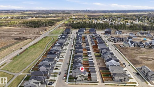 Aerial perspective of a developed residential area featuring multiple single-family homes with dark-pitched roofs and light-colored siding - 17364 2 Street, Edmonton, AB - Outdoor With View