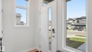 Bright entry area featuring a white door with a vertical glass panel and a smart lock - 17364 2 Street, Edmonton, AB  - Indoor Photo Showing Other Room 