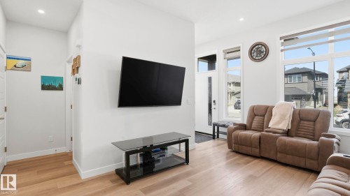 Bright interior space featuring light wood-finish flooring - 17364 2 Street, Edmonton, AB - Indoor Photo Showing Living Room