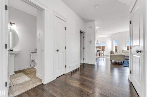 Hallway featuring wood-finish flooring, crisp white walls, and bright white trim - 2292 Casey Crescent, Edmonton, AB - Indoor Photo Showing Other Room