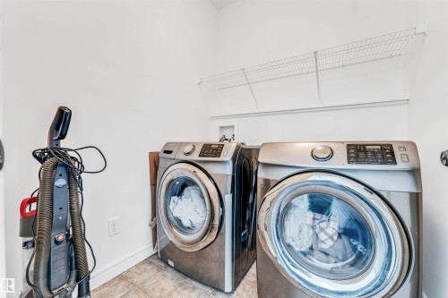 Laundry area featuring white walls, wire shelving, and tiled flooring - 2292 Casey Crescent, Edmonton, AB - Indoor Photo Showing Laundry Room