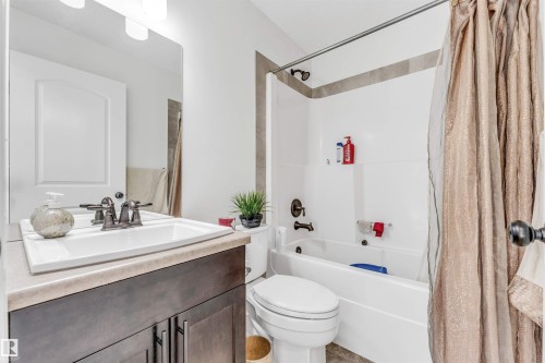 Bathroom featuring a dark wood-finish vanity with a light countertop and an integrated sink - 2292 Casey Crescent, Edmonton, AB - Indoor Photo Showing Bathroom