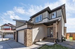 Contemporary two-story residence featuring a multi-textured exterior of siding and brick accents - 