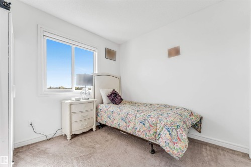 Bright room with a large window, plush carpet flooring, and white painted walls - 2292 Casey Crescent, Edmonton, AB - Indoor Photo Showing Bedroom