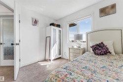 Carpeted room featuring a double-pane window, white walls, and a white door with frosted glass - 