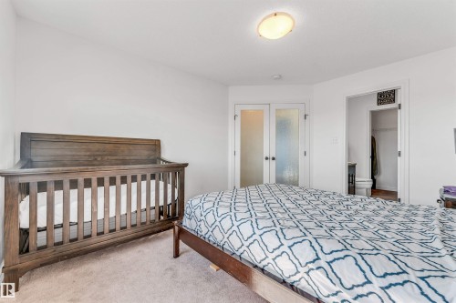 Carpeted bedroom with white walls and a ceiling-mounted light fixture - 2292 Casey Crescent, Edmonton, AB - Indoor Photo Showing Bedroom