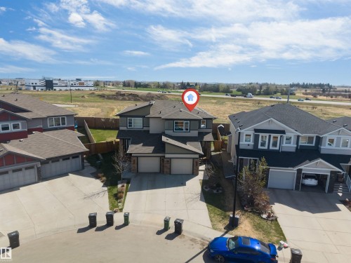 Contemporary detached residence featuring a multi-tone exterior, attached double garage, and a fenced backyard - 2292 Casey Crescent, Edmonton, AB - Outdoor