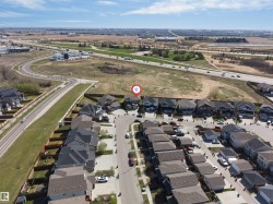 Aerial perspective showcasing a residential development with a consistent architectural style - 