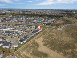 Aerial view showcasing a residential development with structured street layouts and consistent housing designs - 