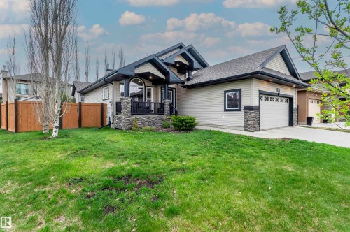 Single-story residence featuring light-colored siding, a dark shingled roof, and a prominent attached garage with a concrete driveway - 19 Newton Place, St. Albert, AB - Outdoor