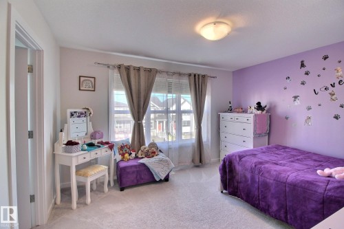 Room featuring light purple walls and a single window with sheer and opaque drapes - 121 Stiles Bend, Leduc, AB - Indoor Photo Showing Bedroom