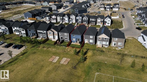 Contemporary two-story home with a blue exterior and dark shingle roof - 121 Stiles Bend, Leduc, AB -  With View