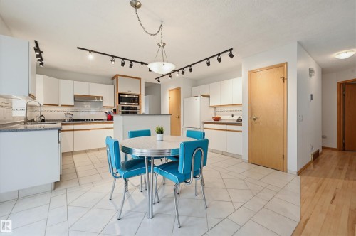 White cabinetry kitchen with tile flooring and a built-in oven - 317 Hollick-Kenyon Road, Edmonton, AB - Indoor