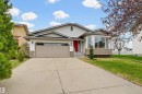 Contemporary residence featuring white horizontal siding and a red front door - 317 Hollick-Kenyon Road, Edmonton, AB  - Outdoor With Facade 