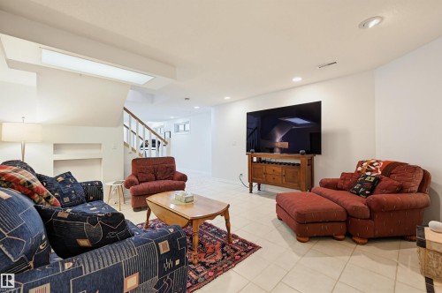 Spacious living area featuring light-colored tile flooring, white walls, and recessed lighting - 317 Hollick-Kenyon Road, Edmonton, AB - Indoor Photo Showing Living Room
