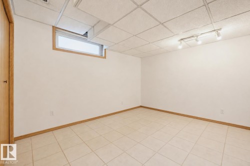Room featuring tile flooring and a drop ceiling with integrated track lighting - 317 Hollick-Kenyon Road, Edmonton, AB - Indoor Photo Showing Other Room