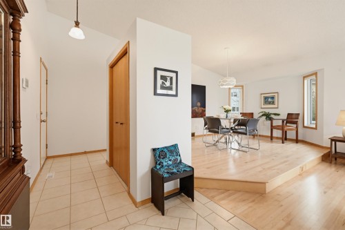Multi-level interior featuring a tiled entry foyer and a raised area with wood-finish flooring - 317 Hollick-Kenyon Road, Edmonton, AB - Indoor