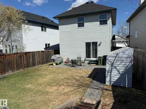 Rear exterior with light gray siding and a dark shingle roof - 645 Windross Crescent, Edmonton, AB 