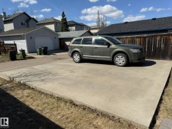 Concrete parking pad providing off-street parking & Ready for YOU to build a GARAGE! - 