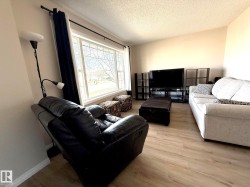 Living area featuring wood-finish flooring and light-toned walls - 